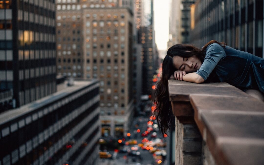 woman leaning on top building rail during daytime